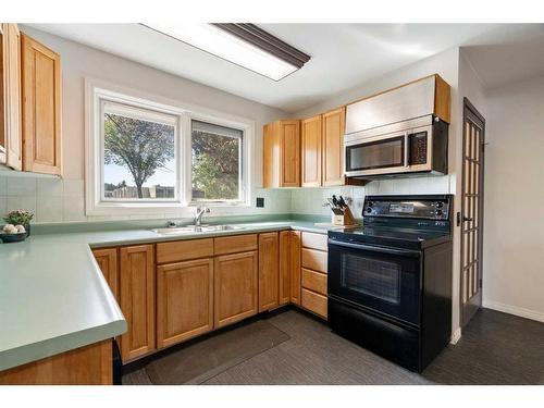 83 Alderwood Close Se, Calgary, AB - Indoor Photo Showing Kitchen With Double Sink