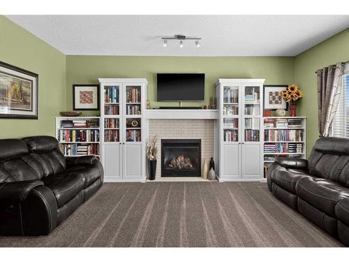 249 New Brighton Lane Se, Calgary, AB - Indoor Photo Showing Living Room With Fireplace