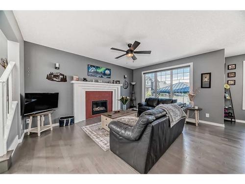 139 Coopersfield Way Sw, Airdrie, AB - Indoor Photo Showing Living Room With Fireplace