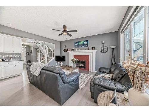 139 Coopersfield Way Sw, Airdrie, AB - Indoor Photo Showing Living Room With Fireplace