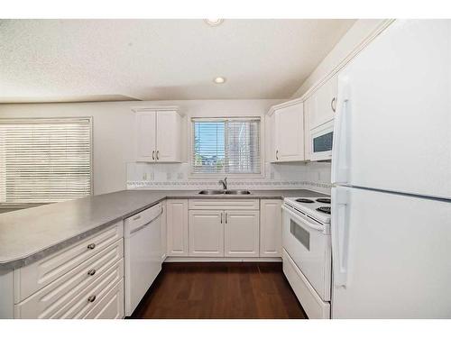 1106-7451 Springbank Boulevard Sw, Calgary, AB - Indoor Photo Showing Kitchen With Double Sink