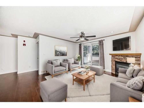 1106-7451 Springbank Boulevard Sw, Calgary, AB - Indoor Photo Showing Living Room With Fireplace