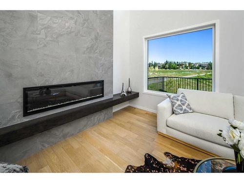 343 Spring Creek Circle Sw, Calgary, AB - Indoor Photo Showing Living Room With Fireplace