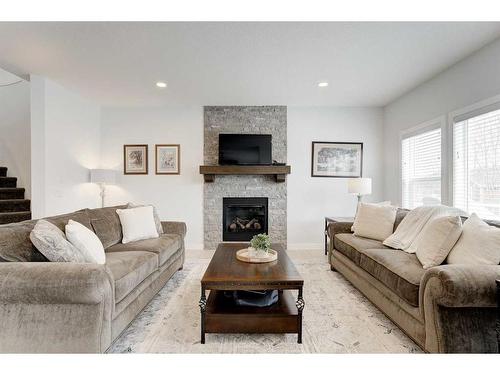 99 Ridge View Close, Cochrane, AB - Indoor Photo Showing Living Room With Fireplace