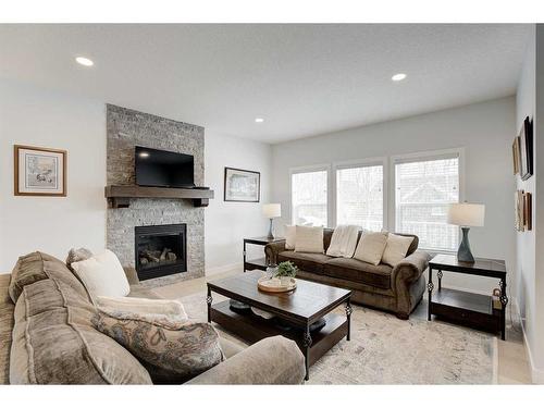 99 Ridge View Close, Cochrane, AB - Indoor Photo Showing Living Room With Fireplace