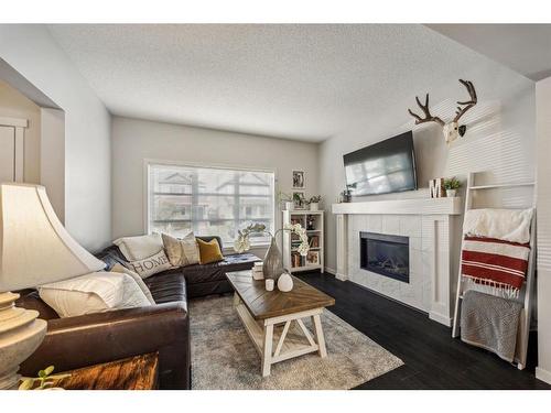 232 Copperpond Parade Se, Calgary, AB - Indoor Photo Showing Living Room With Fireplace