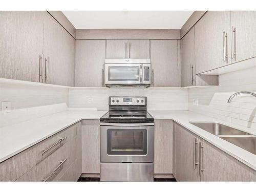 4113-302 Skyview Ranch Drive Ne, Calgary, AB - Indoor Photo Showing Kitchen With Stainless Steel Kitchen With Double Sink