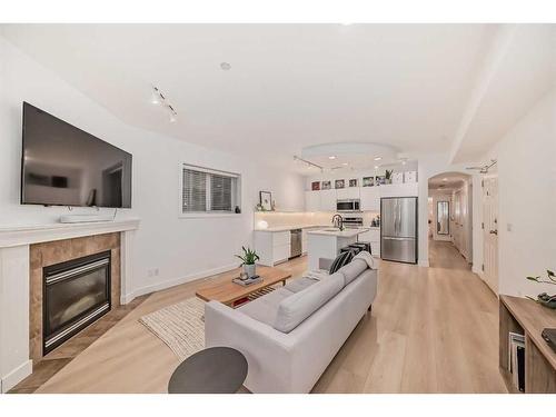 1-824 10 Street Nw, Calgary, AB - Indoor Photo Showing Living Room With Fireplace