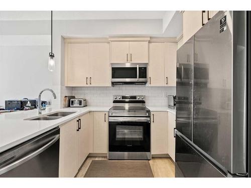 303-100 Harvest Hills Place Ne, Calgary, AB - Indoor Photo Showing Kitchen With Stainless Steel Kitchen With Double Sink