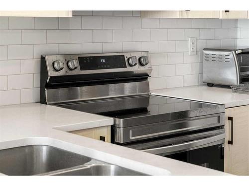 303-100 Harvest Hills Place Ne, Calgary, AB - Indoor Photo Showing Kitchen With Double Sink