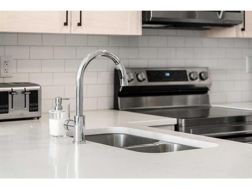 303-100 Harvest Hills Place Ne, Calgary, AB - Indoor Photo Showing Kitchen With Double Sink