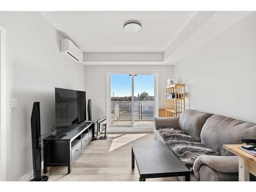 303-100 Harvest Hills Place Ne, Calgary, AB - Indoor Photo Showing Living Room