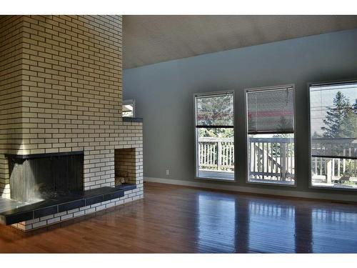 1165 Hunterston Hill Nw, Calgary, AB - Indoor Photo Showing Living Room With Fireplace