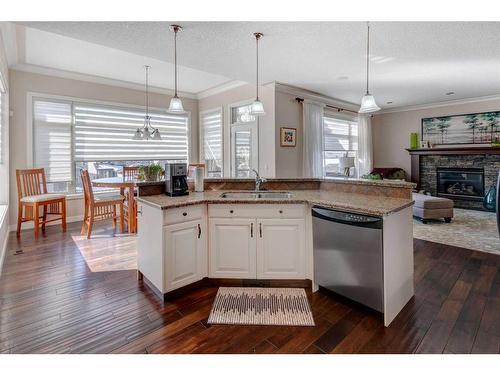 16 Sunset Close, Cochrane, AB - Indoor Photo Showing Kitchen With Fireplace With Double Sink