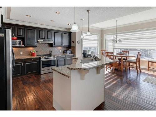 16 Sunset Close, Cochrane, AB - Indoor Photo Showing Kitchen With Double Sink With Upgraded Kitchen