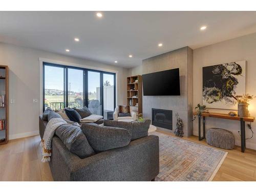 34-130 Discovery Drive Sw, Calgary, AB - Indoor Photo Showing Living Room With Fireplace