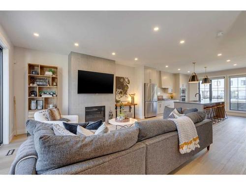 34-130 Discovery Drive Sw, Calgary, AB - Indoor Photo Showing Living Room With Fireplace