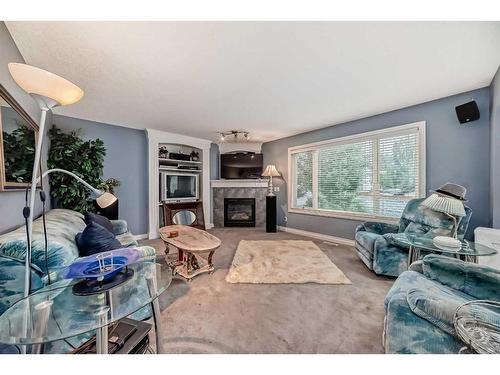 112 Oakmere Place, Chestermere, AB - Indoor Photo Showing Living Room With Fireplace