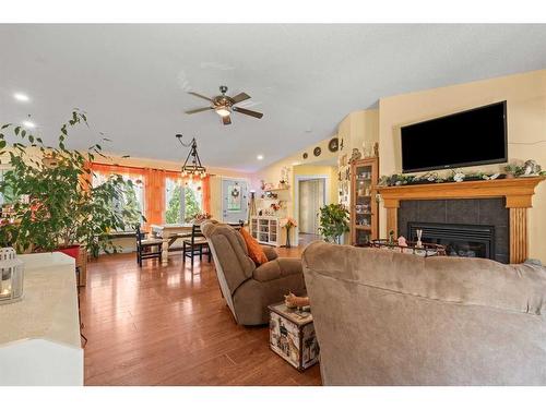 115 Dunham Lane, Diamond Valley, AB - Indoor Photo Showing Living Room With Fireplace