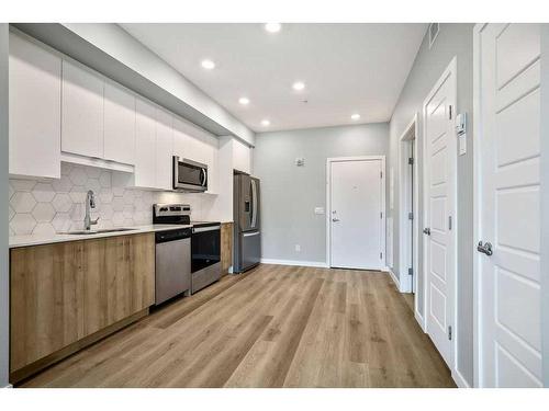 107-1605 17 Street Se, Calgary, AB - Indoor Photo Showing Kitchen With Stainless Steel Kitchen