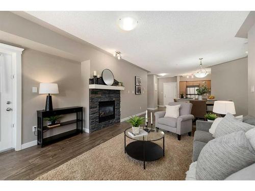 203-30 Discovery Ridge Close Sw, Calgary, AB - Indoor Photo Showing Living Room With Fireplace