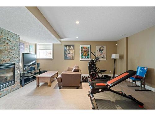 1626A 41 Street Sw, Calgary, AB - Indoor Photo Showing Gym Room With Fireplace