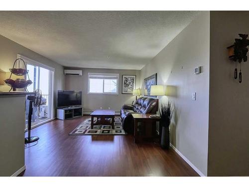 2226-10 Prestwick Bay Se, Calgary, AB - Indoor Photo Showing Living Room