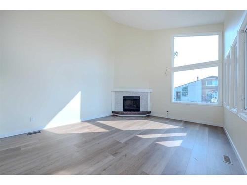 301 Fonda Way Se, Calgary, AB - Indoor Photo Showing Living Room With Fireplace