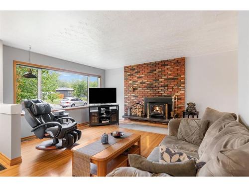 42 Malibou Road Sw, Calgary, AB - Indoor Photo Showing Living Room With Fireplace