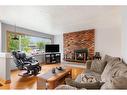 42 Malibou Road Sw, Calgary, AB  - Indoor Photo Showing Living Room With Fireplace 