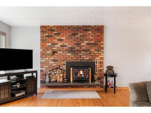 42 Malibou Road Sw, Calgary, AB - Indoor Photo Showing Living Room With Fireplace