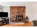 42 Malibou Road Sw, Calgary, AB  - Indoor Photo Showing Living Room With Fireplace 