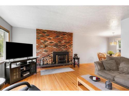 42 Malibou Road Sw, Calgary, AB - Indoor Photo Showing Living Room With Fireplace