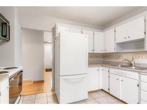 42 Malibou Road Sw, Calgary, AB - Indoor Photo Showing Kitchen With Double Sink