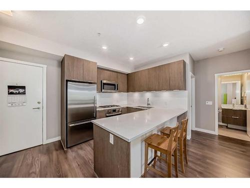 109-823 5 Avenue Nw, Calgary, AB - Indoor Photo Showing Kitchen With Stainless Steel Kitchen With Upgraded Kitchen