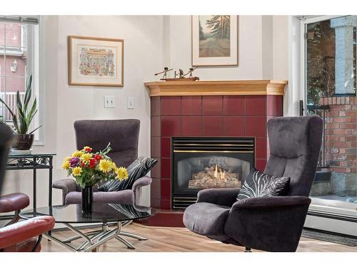 110-1415 17 Street Se, Calgary, AB - Indoor Photo Showing Living Room With Fireplace