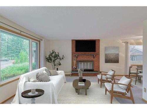 115 Queen Charlotte Place Se, Calgary, AB - Indoor Photo Showing Living Room With Fireplace