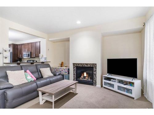 125 Chapalina Square Se, Calgary, AB - Indoor Photo Showing Living Room With Fireplace