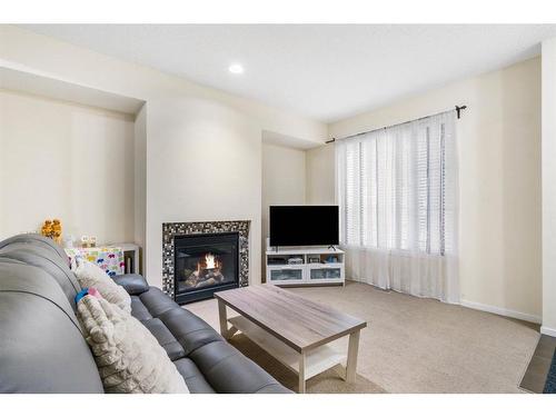 125 Chapalina Square Se, Calgary, AB - Indoor Photo Showing Living Room With Fireplace