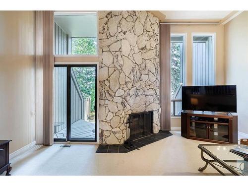 4-10457 19 Street Sw, Calgary, AB - Indoor Photo Showing Living Room With Fireplace