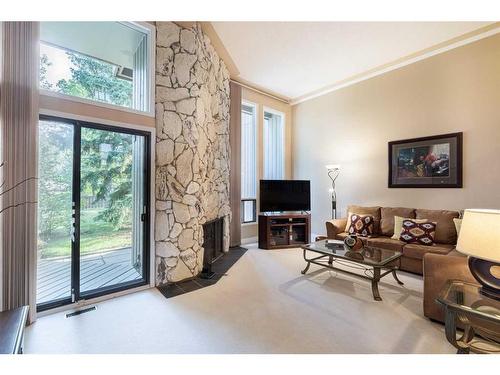 4-10457 19 Street Sw, Calgary, AB - Indoor Photo Showing Living Room With Fireplace