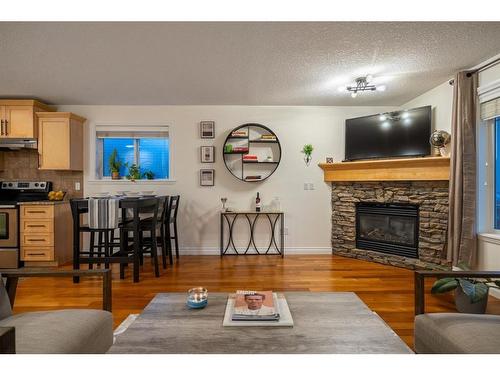 202-1920 26 Street Sw, Calgary, AB - Indoor Photo Showing Living Room With Fireplace