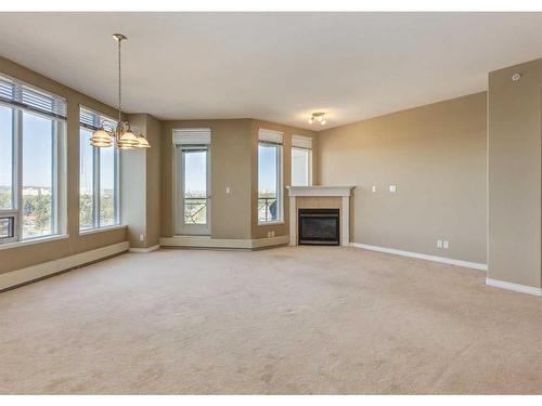 604-1726 14 Avenue Nw, Calgary, AB - Indoor Photo Showing Other Room With Fireplace