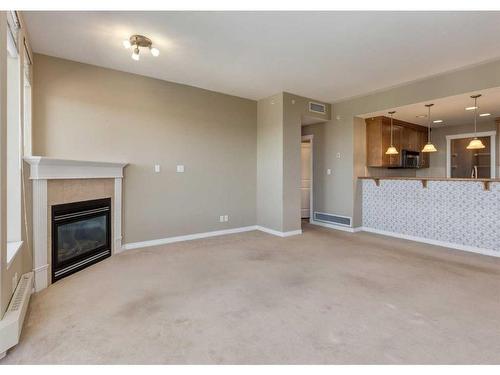 604-1726 14 Avenue Nw, Calgary, AB - Indoor Photo Showing Living Room With Fireplace