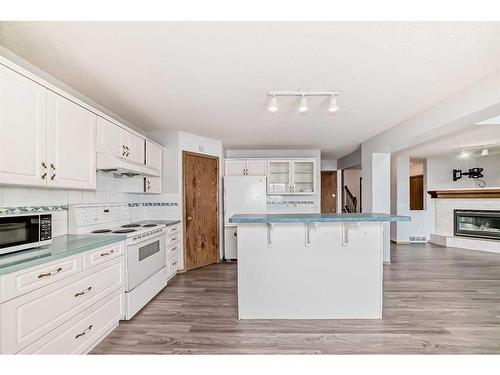 172 Panorama Hills Place Nw, Calgary, AB - Indoor Photo Showing Kitchen With Fireplace