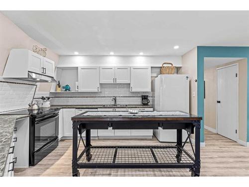 929 17Th Street, Canmore, AB - Indoor Photo Showing Kitchen With Double Sink