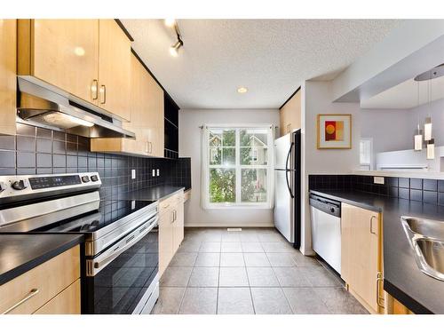 217 Toscana Gardens Nw, Calgary, AB - Indoor Photo Showing Kitchen With Stainless Steel Kitchen With Double Sink