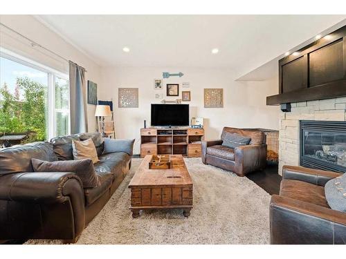 11 Storm Mountain Place, Okotoks, AB - Indoor Photo Showing Living Room With Fireplace