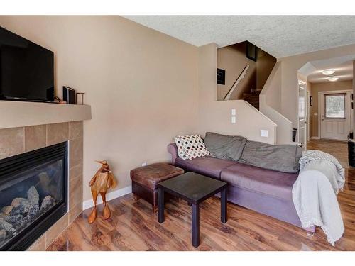 120-413 River Avenue, Cochrane, AB - Indoor Photo Showing Living Room With Fireplace