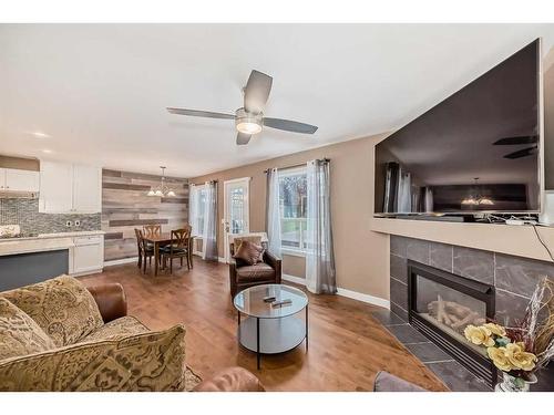 63 Chapalina Crescent Se, Calgary, AB - Indoor Photo Showing Living Room With Fireplace